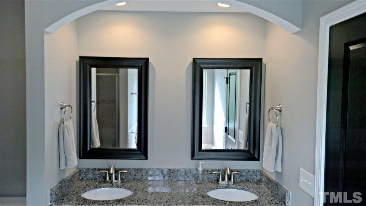 5619 Wade Park Boulevard Raleigh, NC 27607 - Photo 5 of 11 a bathroom with a sink and a mirror