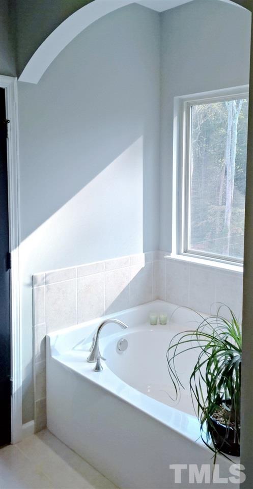 5619 Wade Park Boulevard Raleigh, NC 27607 - Photo 6 of 11 a bathroom with bathtub and window