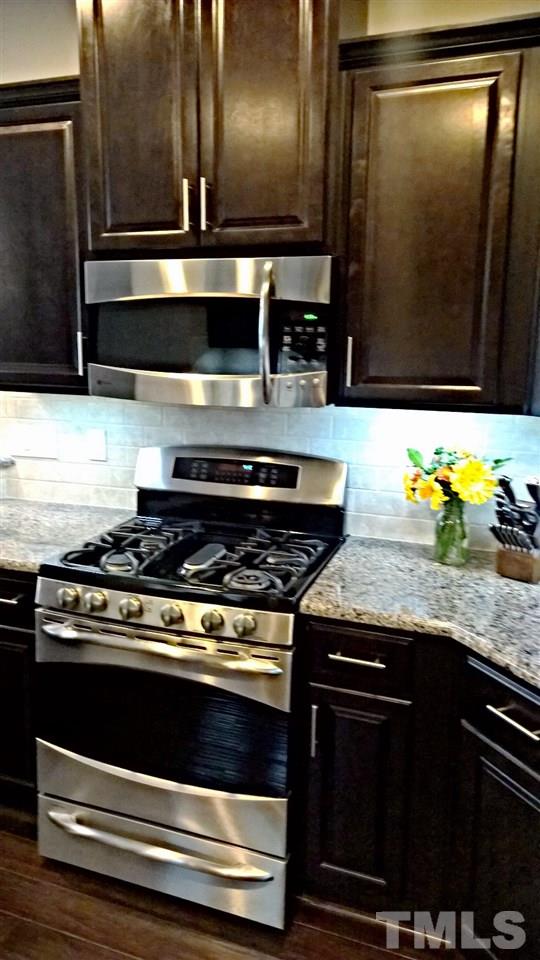 5619 Wade Park Boulevard Raleigh, NC 27607 - Photo 7 of 11 a stove top oven sitting inside of a kitchen