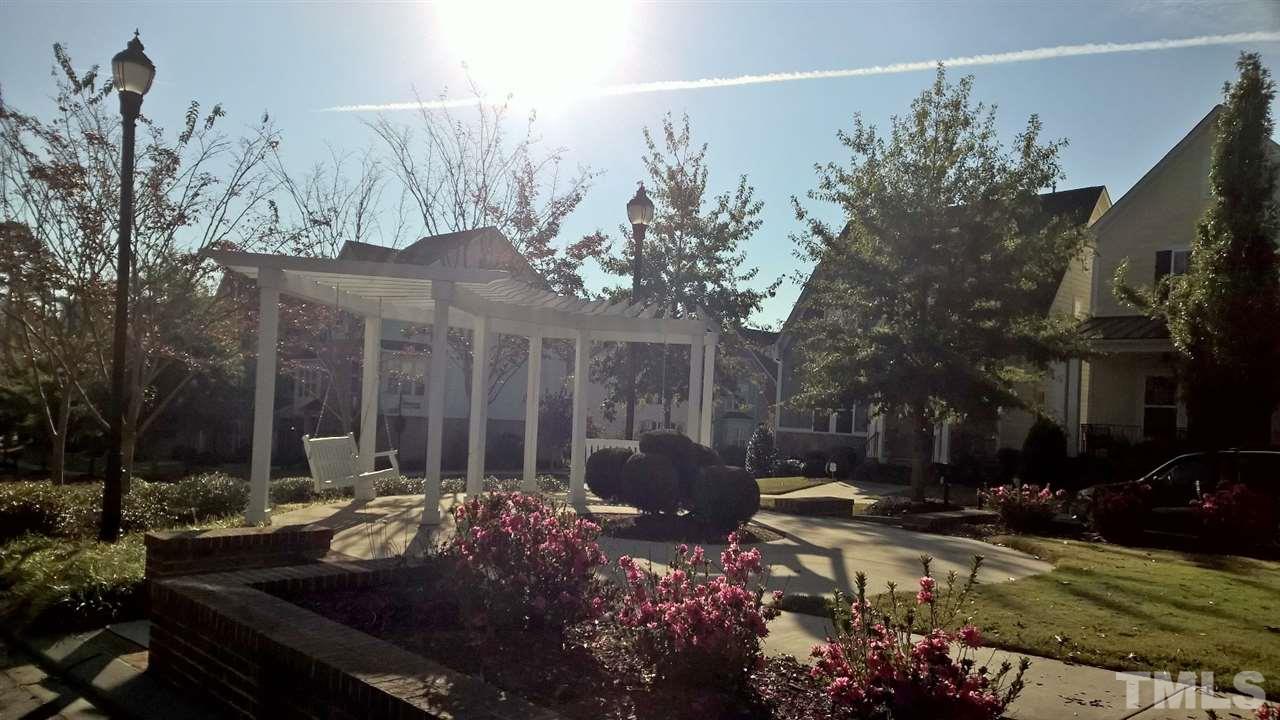 5619 Wade Park Boulevard Raleigh, NC 27607 - Photo 8 of 11 a front view of a house with a yard and trees