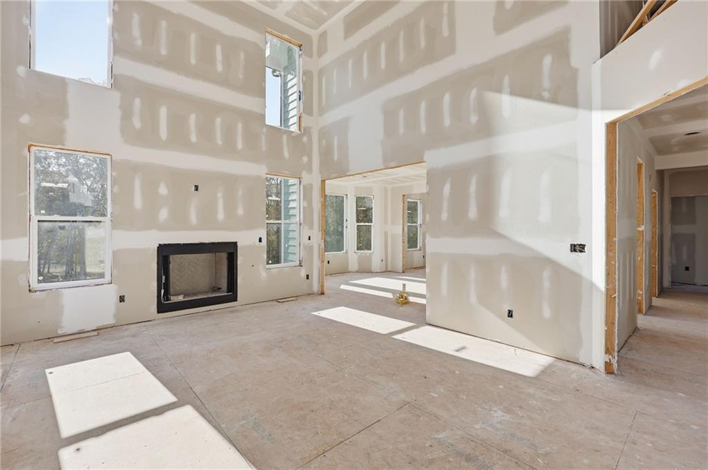 3613 Schofield Road Gainesville, GA 30506 - Photo 19 of 42 a view of an empty room with a fireplace and a window