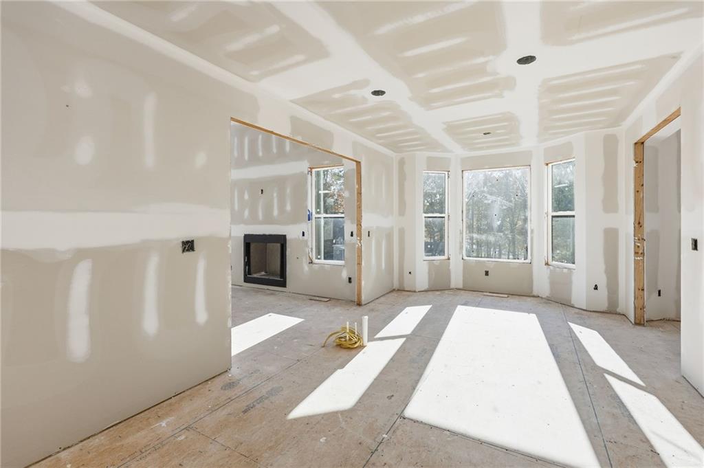 3613 Schofield Road Gainesville, GA 30506 - Photo 21 of 42 a spacious bedroom with a large bed and chandelier