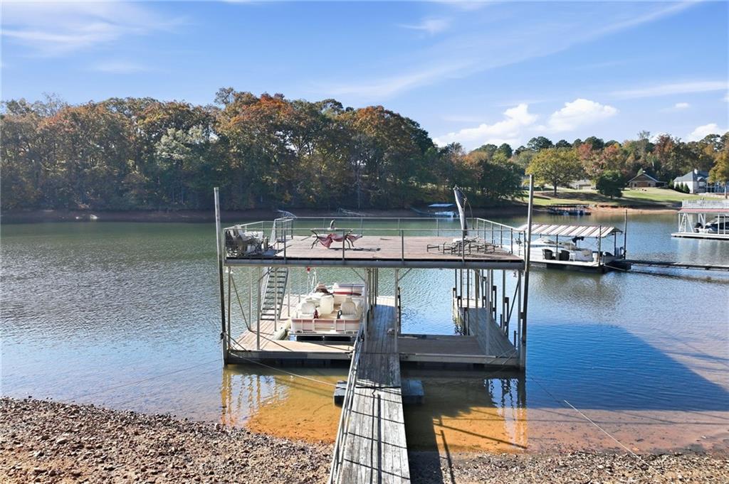 3613 Schofield Road Gainesville, GA 30506 - Photo 8 of 42 a view of a lake with boats and trees in the background