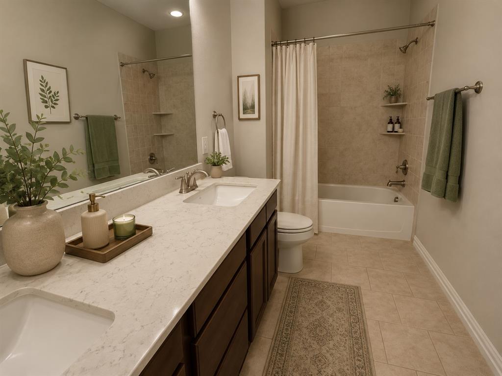 14128 El Toro Road Frisco, TX 75035 - Photo 8 of 19 Bathroom featuring a double vanity with stone countertops, integrated sinks, and dark wood-finish cabinetry