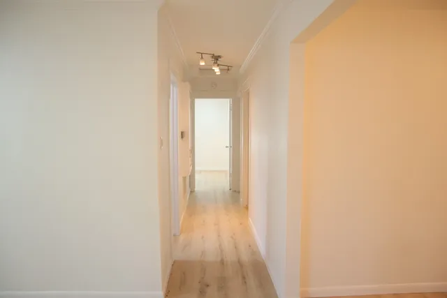 a view of a room with wooden floor
