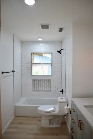a bathroom with a toilet a sink and bathtub