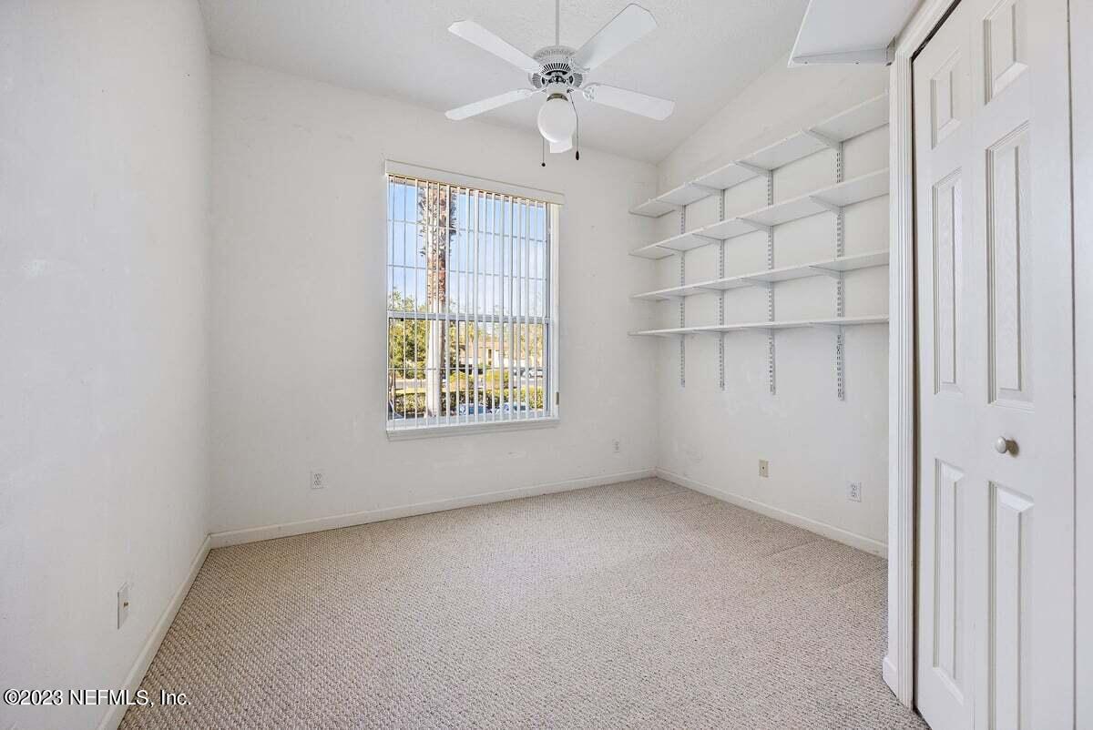 811 Pine Valley Place St. Augustine, FL 32086 - Photo 13 of 30 an empty room with a window and ceiling fan