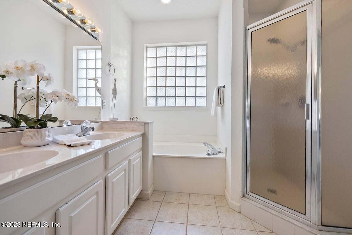 811 Pine Valley Place St. Augustine, FL 32086 - Photo 18 of 30 a bathroom with a bathtub shower sink and mirror