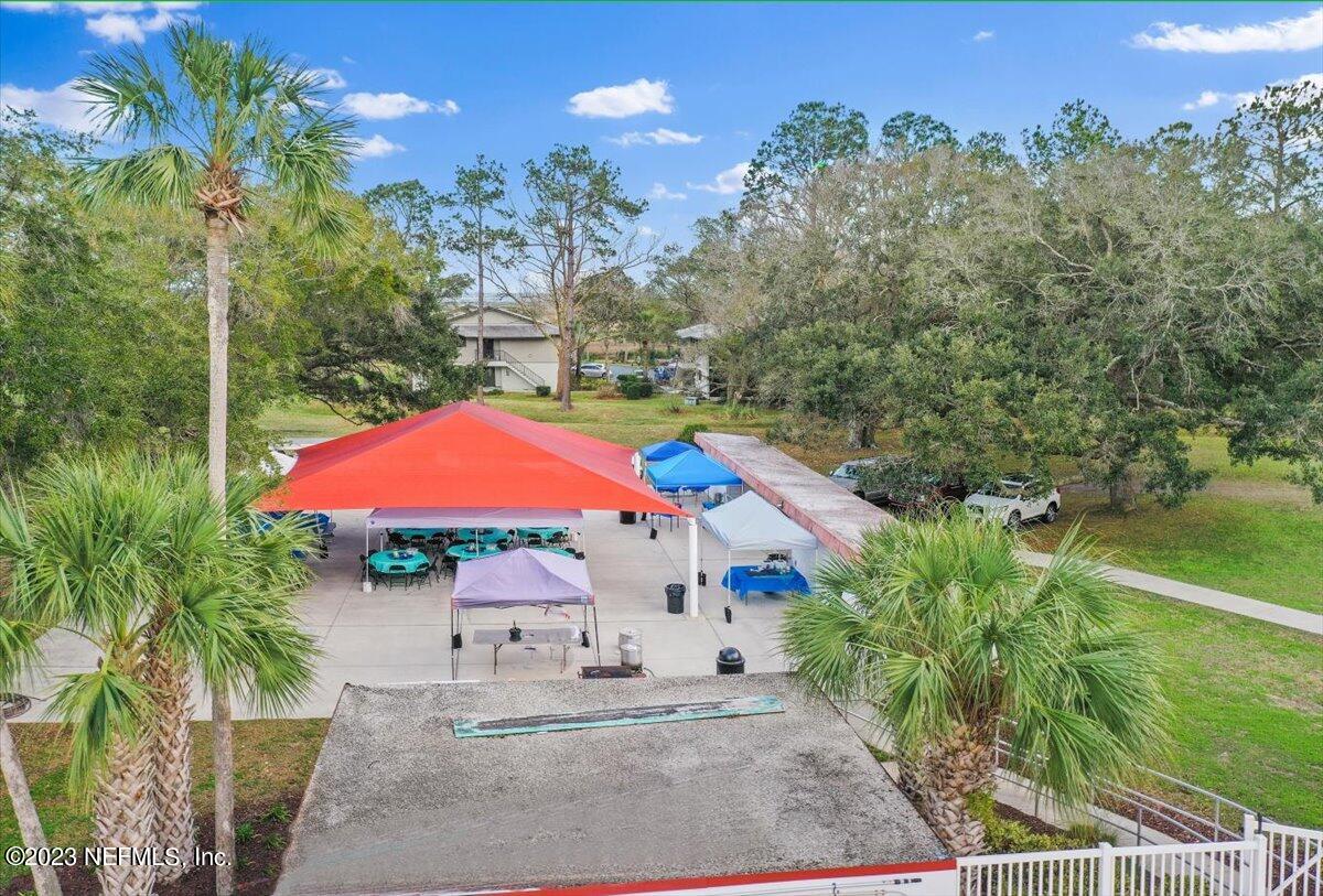 811 Pine Valley Place St. Augustine, FL 32086 - Photo 28 of 30 an outdoor space with furniture and umbrella