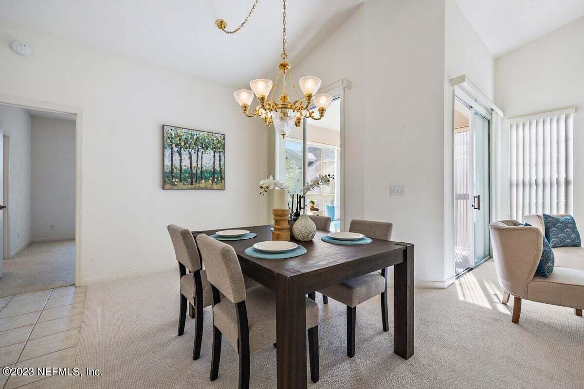 811 Pine Valley Place St. Augustine, FL 32086 - Photo 7 of 30 a view of a dining room with furniture and a chandelier