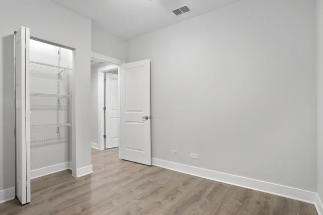 an empty room with wooden floor