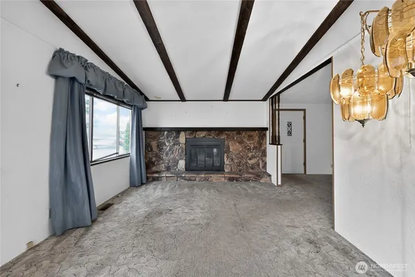 a view of empty room with window and fireplace