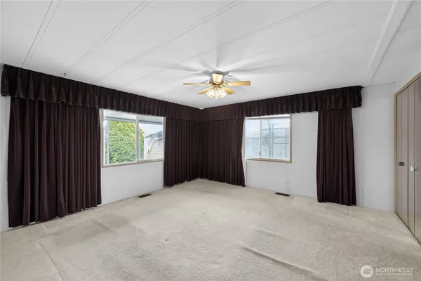 a view of a livingroom with a ceiling fan and window