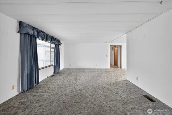 a view of empty room with floor to ceiling window