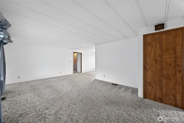 a view of an empty room and a window
