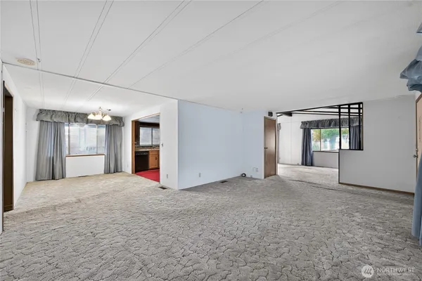 a view of a big room with windows and cabinet