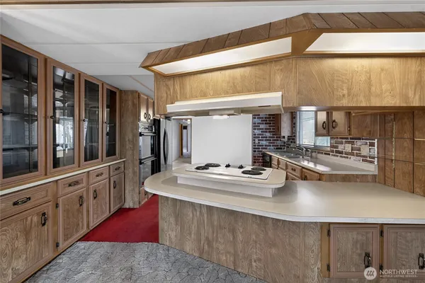a kitchen with counter top space and stainless steel appliances