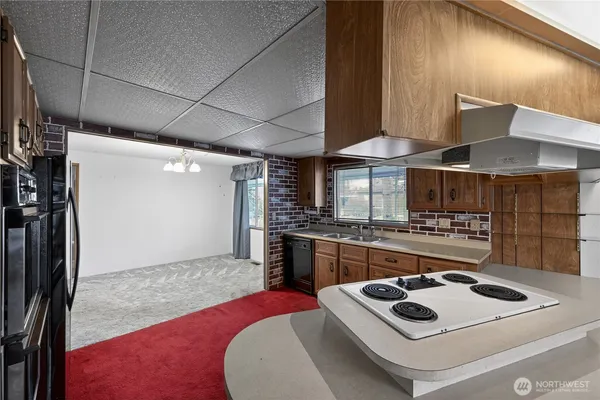 a kitchen with a stove a sink and a refrigerator
