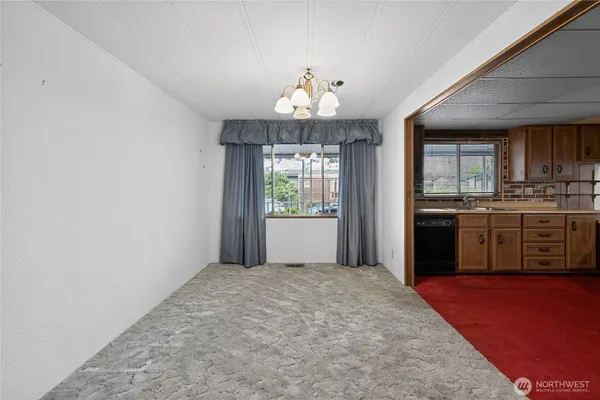 a view of a kitchen with dishwasher and wooden floor