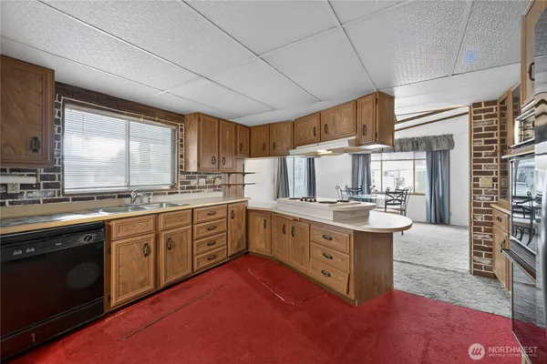 a kitchen with stainless steel appliances granite countertop a sink stove and cabinets