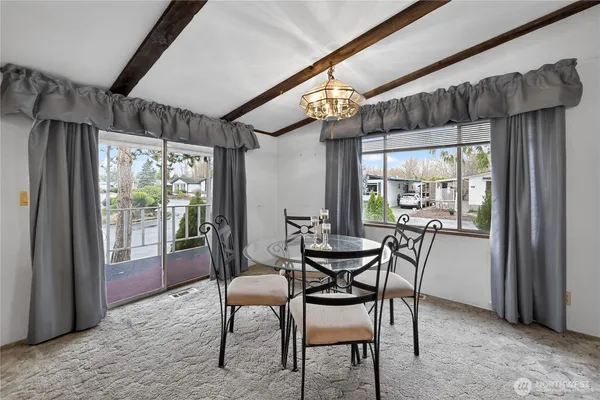 a dining room with furniture and window