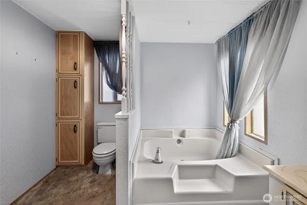 a bathroom with a bathtub and a shower