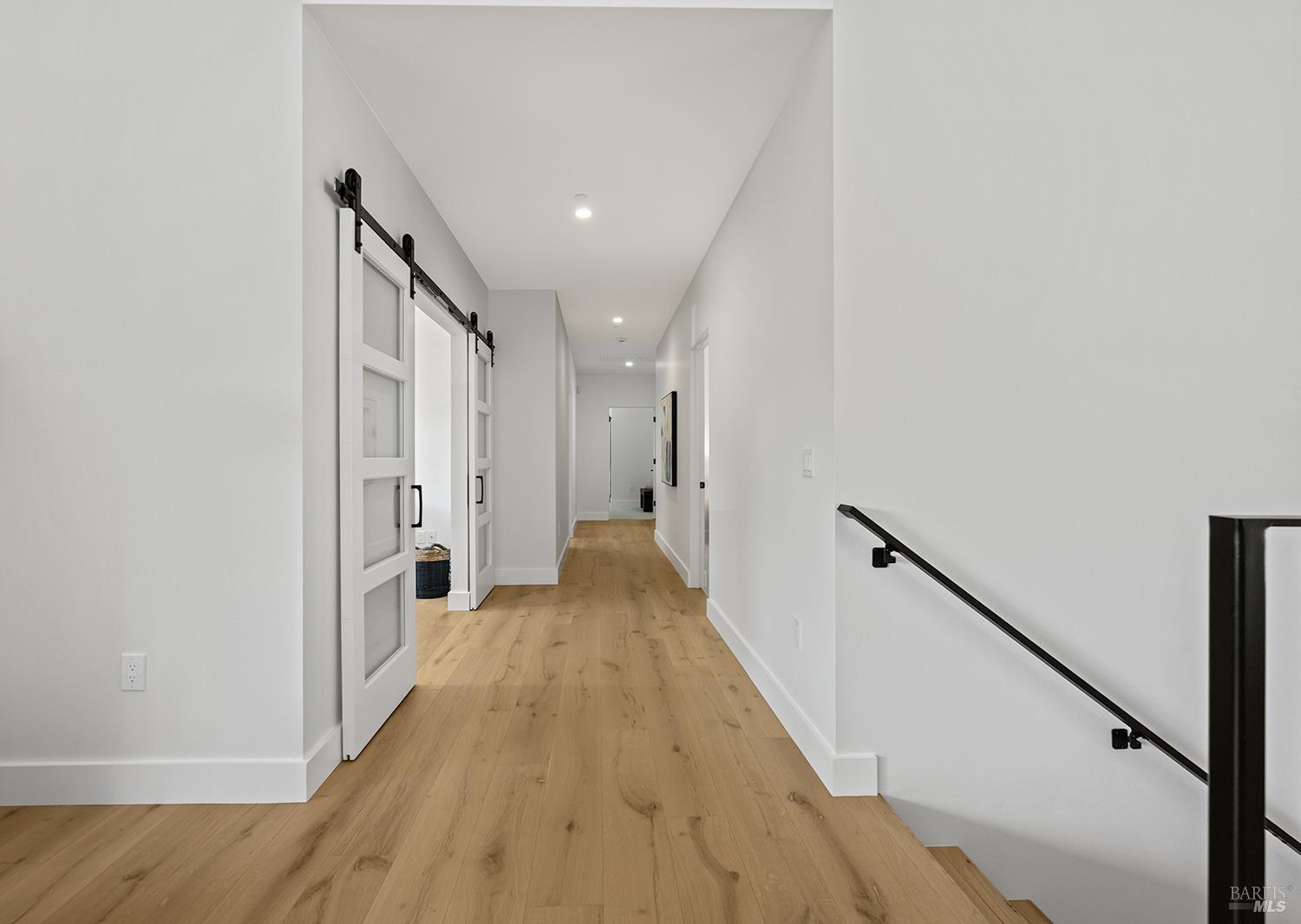 573 Wagnon Road Sebastopol, CA 95472 - Photo 28 of 53 Hallway leading to bedrooms from kitchen with stairs leading down to the six-car garage and flexible ADU space