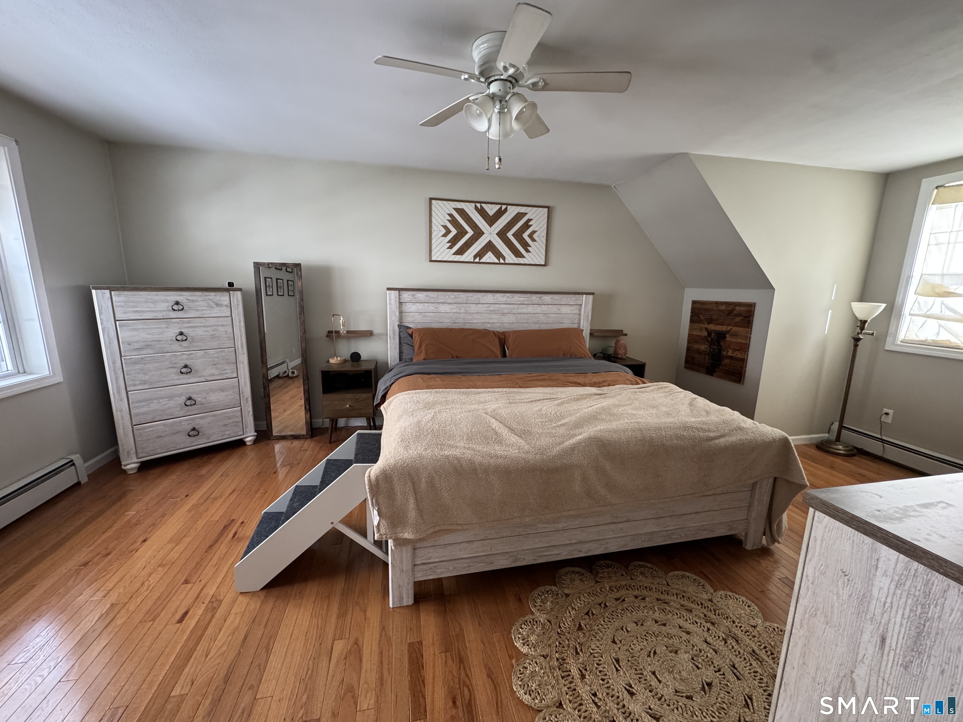 237 Chestnut Hill Road Killingworth, CT 06419 - Photo 20 of 39 a bedroom with a bed and a chandelier