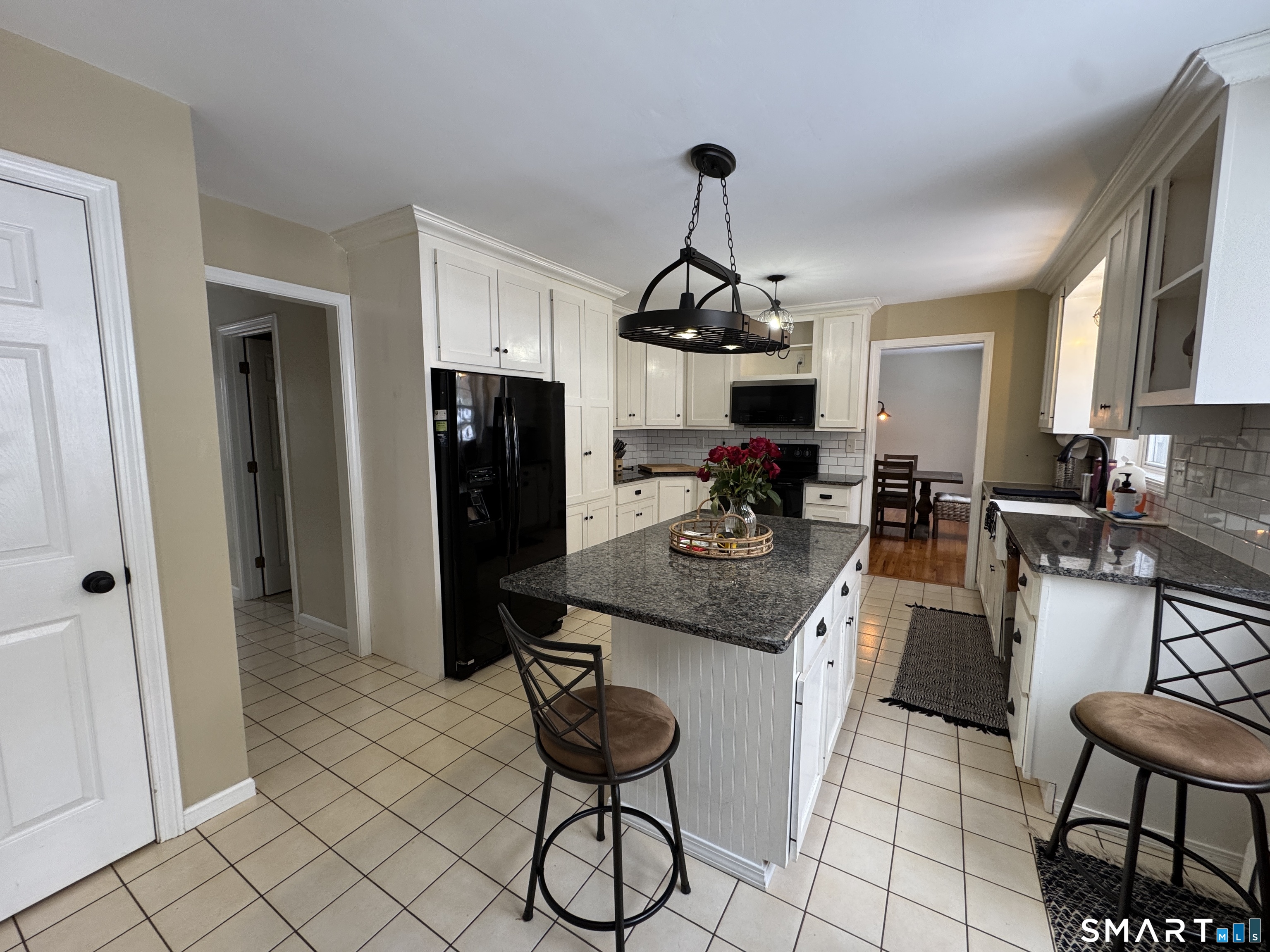 237 Chestnut Hill Road Killingworth, CT 06419 - Photo 10 of 39 a kitchen with stainless steel appliances kitchen island granite countertop a sink and a refrigerator