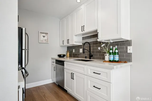 a living room with furniture a chandelier and a wooden floor