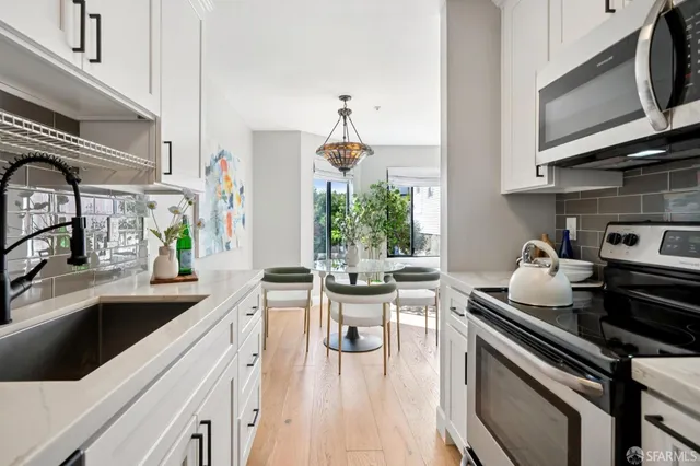 a kitchen with white cabinets and white appliances