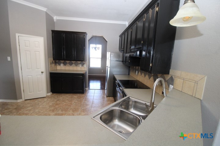 775 Cactus Lane Copperas Cove, TX 76522 - Photo 4 of 22 a kitchen with granite countertop a sink and a stove top oven