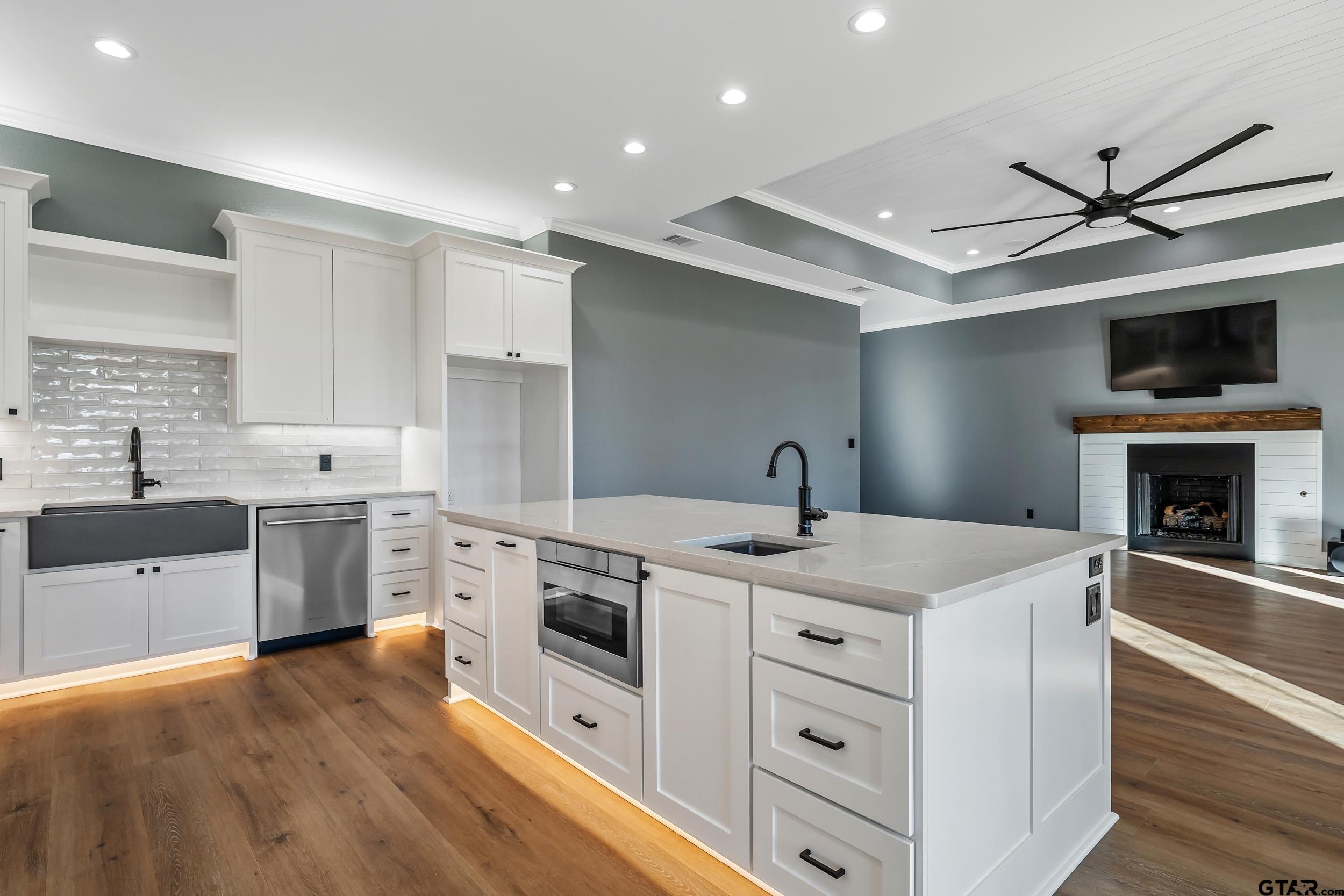 12241 Madison Crossing Bullard, TX 75757 - Photo 19 of 38 a kitchen with a stove sink and a refrigerator