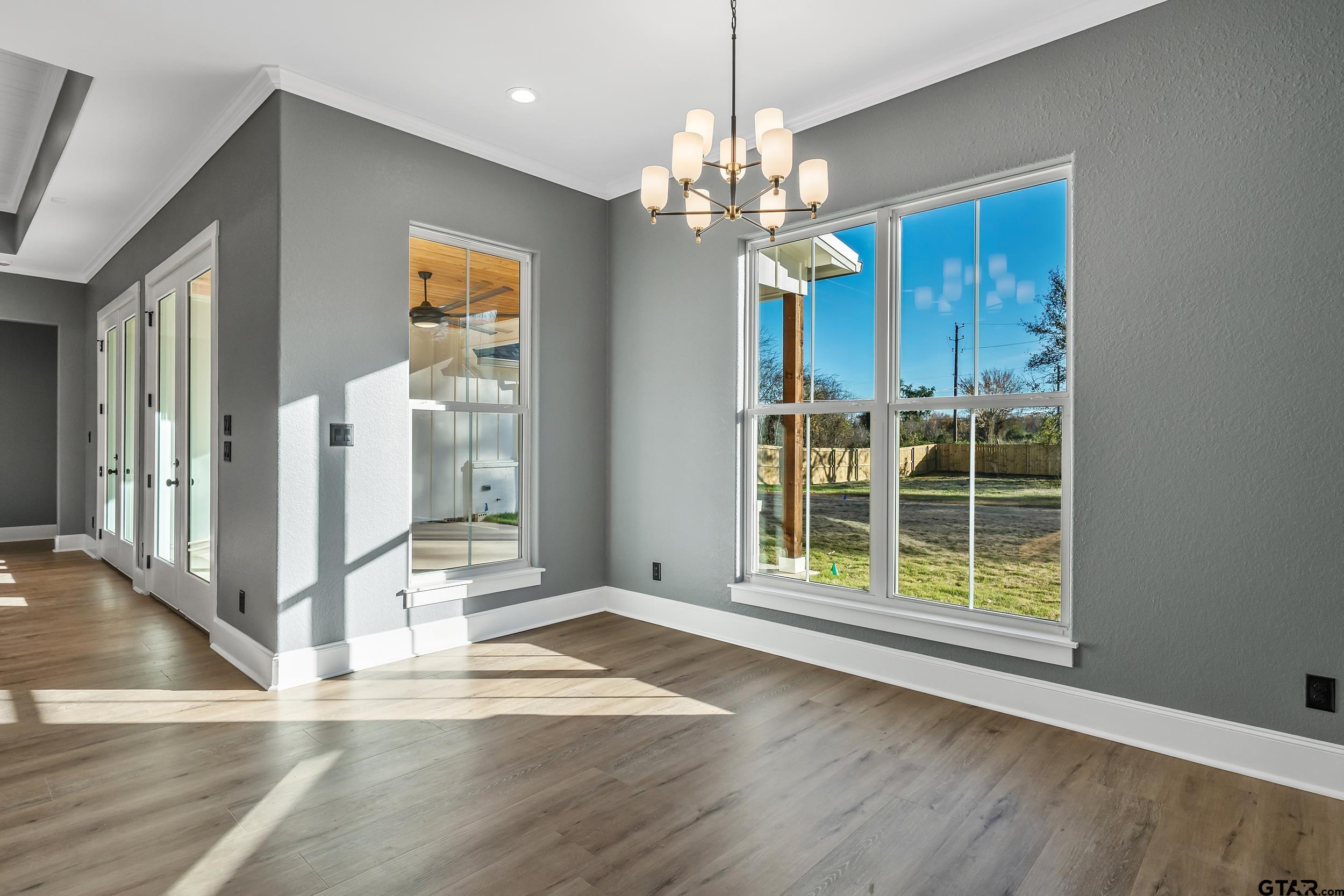 12241 Madison Crossing Bullard, TX 75757 - Photo 24 of 38 a view of a livingroom with wooden floor and a ceiling fan