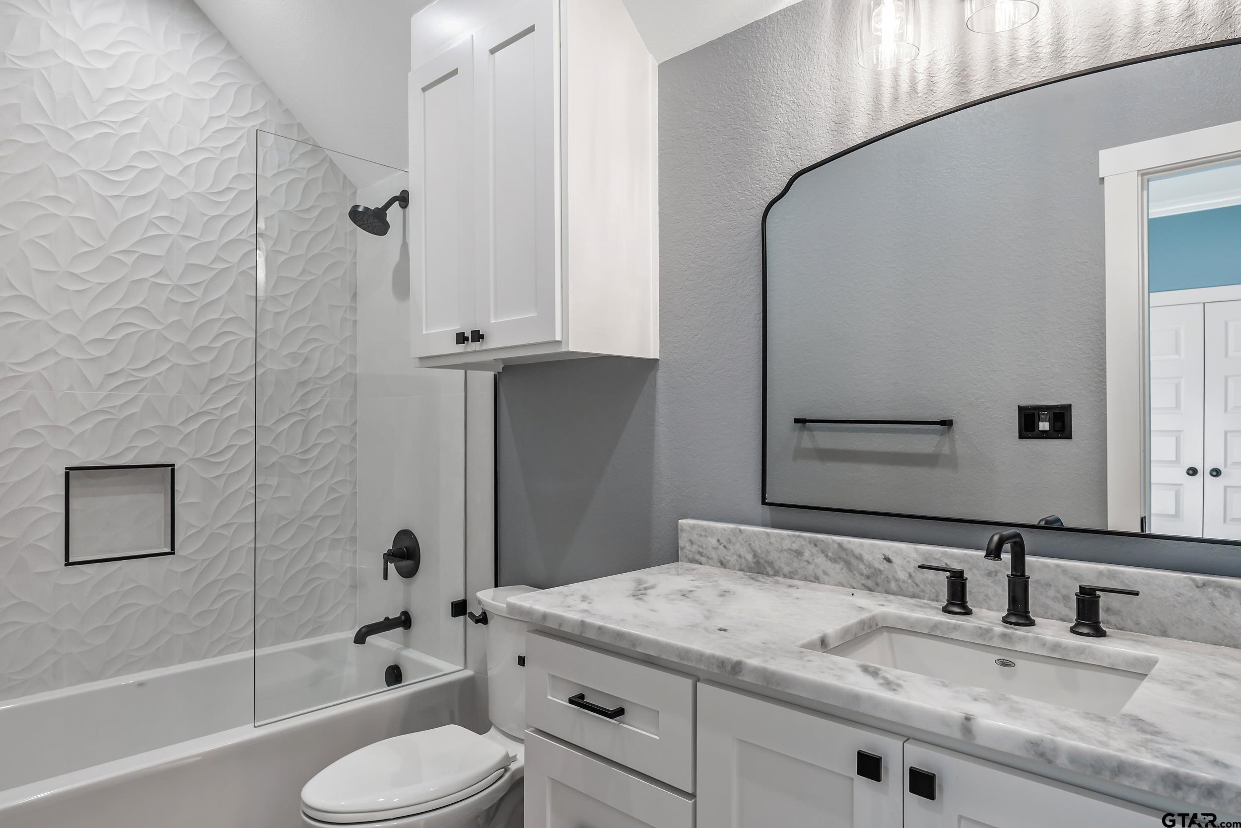 12241 Madison Crossing Bullard, TX 75757 - Photo 35 of 38 a bathroom with a granite countertop sink toilet and shower