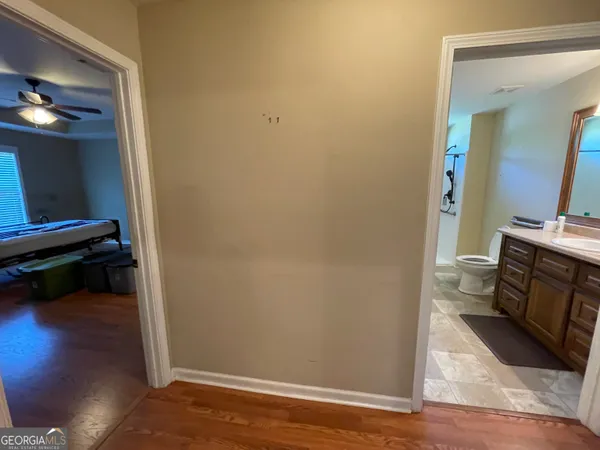 a view of utility room with wooden floor and fan