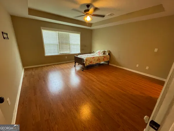 a spacious bedroom with a bed and a window