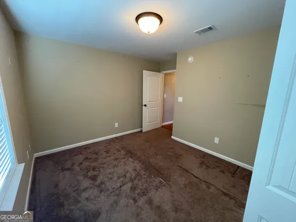 an empty room with a fan