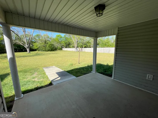 a front view of a house with yard and green space
