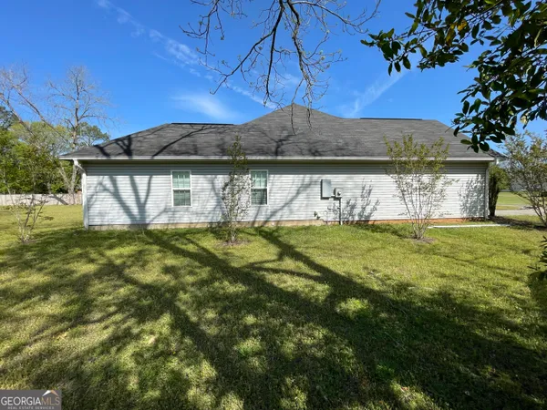 a view of house with garden space and street view