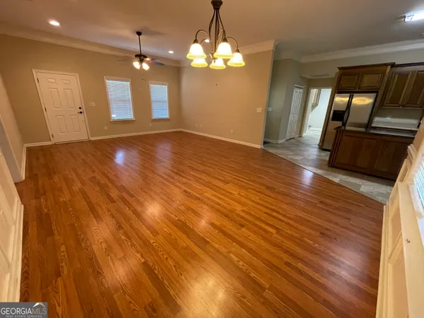 a view of a room with wooden floor