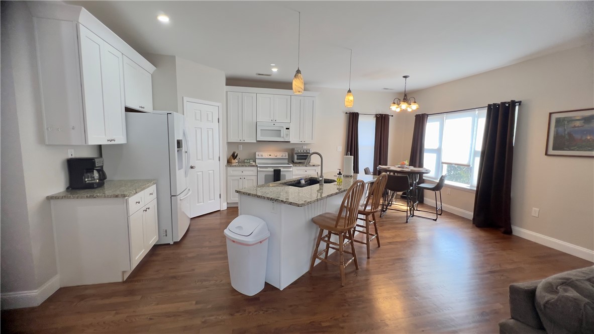 160 Hudgins Lake Road Townville, SC 29689 - Photo 9 of 41 A well-lit kitchen with granite countertops and an inviting island, perfect for casual dining and entertaining.