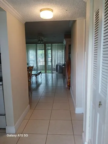 a room with pool table and windows