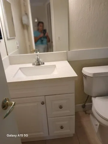 a white toilet sitting next to a shower curtain