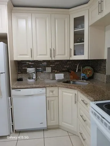 a stove top oven sitting inside of a kitchen