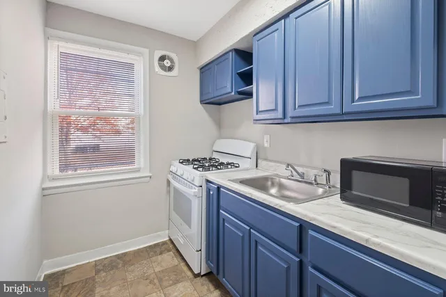 a kitchen with granite countertop cabinets stainless steel appliances and a sink