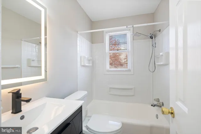 a bathroom with a sink vanity tub and shower