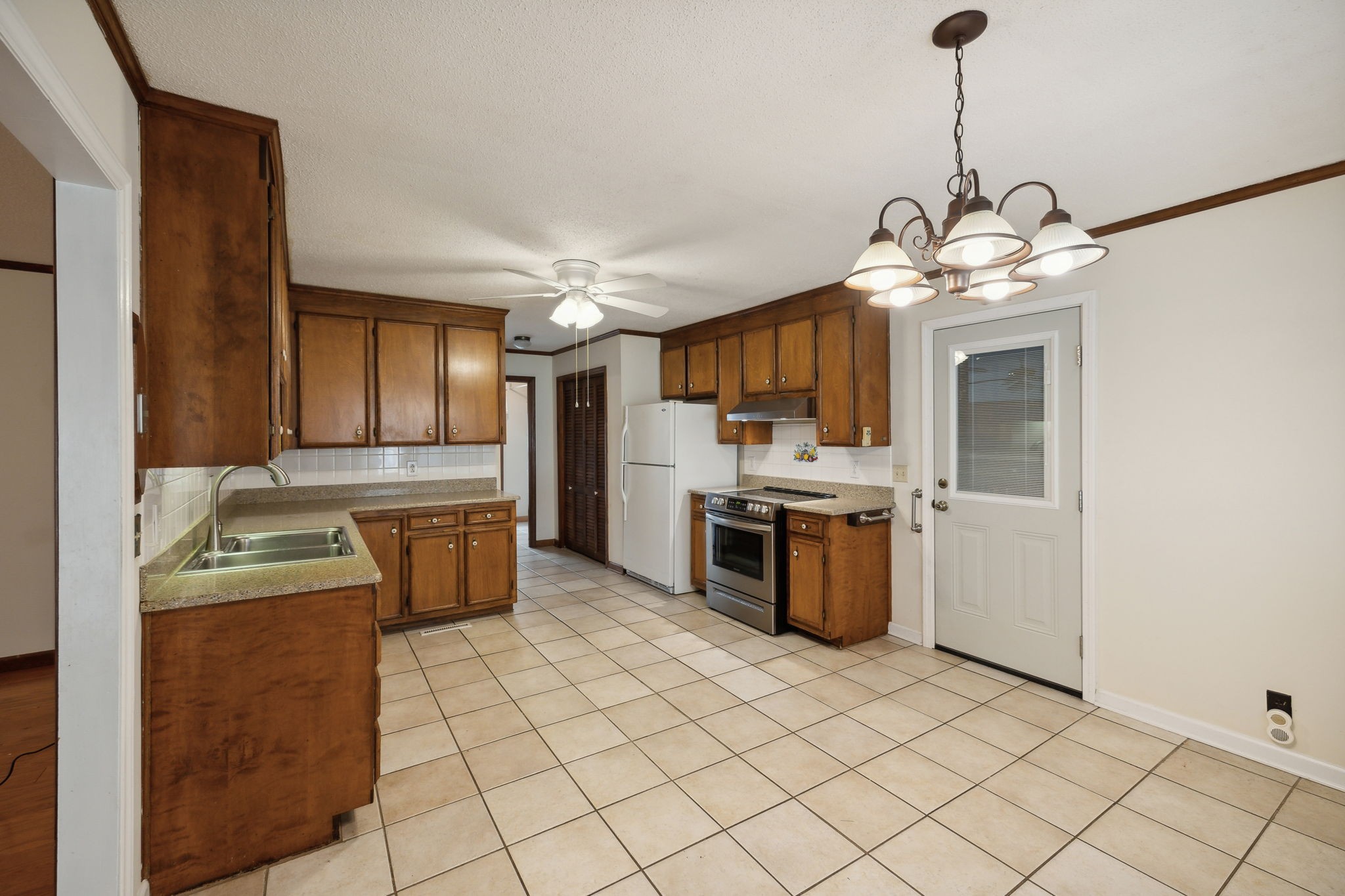 4068 Confederate Road Murfreesboro, TN 37128 - Photo 17 of 53 There's a stainless Stove with Hood and stainless Dishwasher. The Refrigerator is white, and all appliances remain. Doorway leads to the 2-car garage.