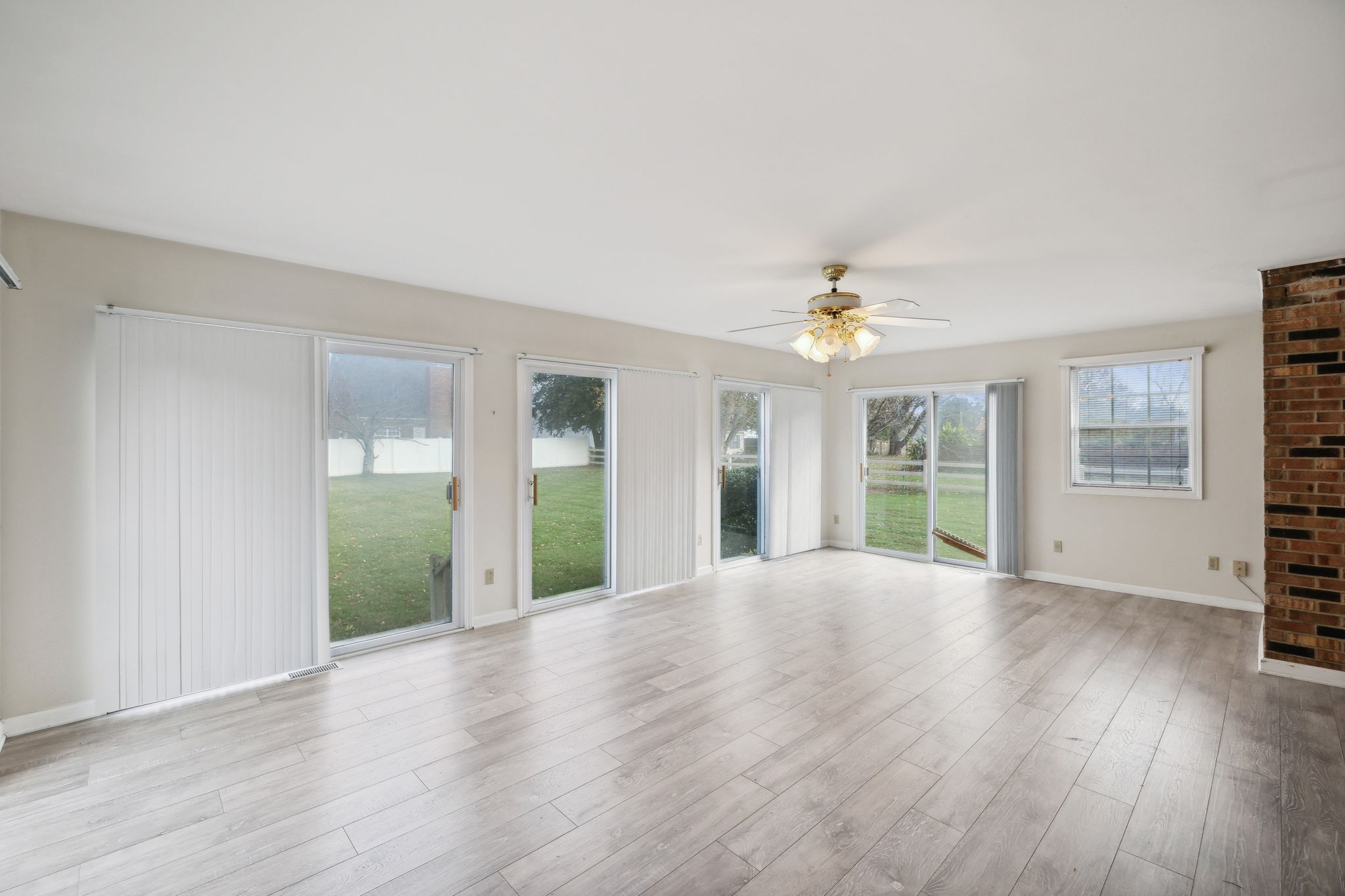 4068 Confederate Road Murfreesboro, TN 37128 - Photo 24 of 53 The Sunroom which was a later addition to the home - 5 sets of sliding doors and laminate flooring - this would be a great hang-out area!