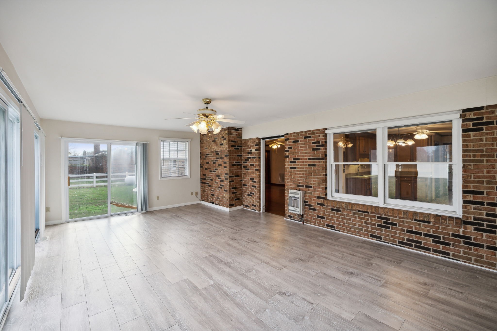 4068 Confederate Road Murfreesboro, TN 37128 - Photo 25 of 53 A look toward the Living Room doorway in the Sunroom. There is a built-in heater for this room on the brick wall.